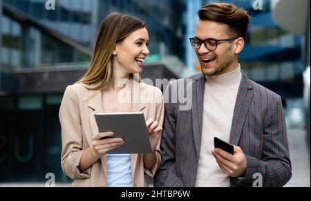 Two creative business people working on social media strategy using a digital tablet Stock Photo