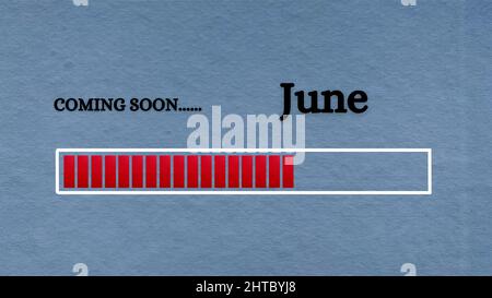 Top view of loading bar with text - Coming soon June. Light blue background. Stock Photo