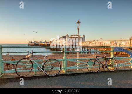 14 January 2022: Brighton, East Sussex, UK - Brighton Pier on a sunny winter morning, with bicycles on the promenade. Stock Photo