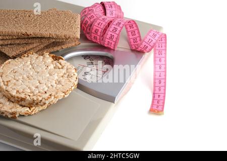 https://l450v.alamy.com/450v/2htc5gw/wheat-and-rye-bread-floor-scales-and-measuring-tape-on-a-white-backgroundhealthy-food-for-weight-loss-2htc5gw.jpg