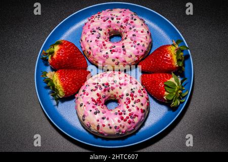 delicious donuts and strawberries on a plate Stock Photo