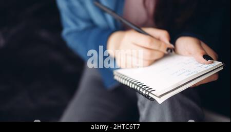 Closeup shot of a female hand doing some notes Stock Photo