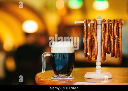 Salted soft pretzels and beer on the table in the bar Stock Photo