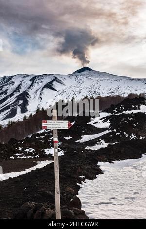 A footpath sign high on the rugged slopes of Mount Etna, Sicily, Italy. There are many long distance hiking trails around the volcano Stock Photo