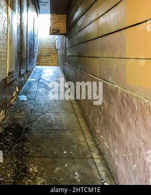 A dirty entrance with stairs in the background Stock Photo