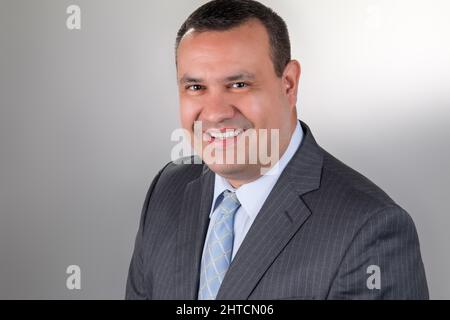 Closeup shot of a Hispanic man smiling and looking into the camera in Argentina Stock Photo