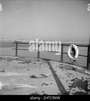 Weymouth, Weymouth and Portland, Dorset, probably Jun 1948. A view looking in a north-westerly direction from near the entrance to Weymouth Harbour, showing a lifebuoy in the foreground hanging from quayside railings. This photograph was taken during a Laing staff outing to Weymouth. Although no date has been recorded by the photographer, a staff outing is known to have taken place in June 1948.