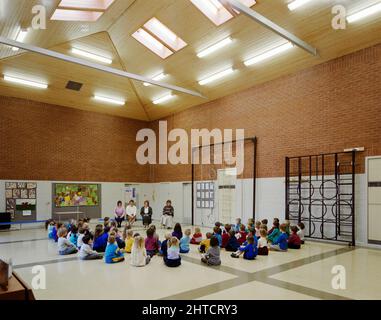 Whingate Primary School, Whingate Road, Leeds, 09/03/1989. Children sitting on the floor in the assembly room at Whingate Primary School, Leeds. Laing's Yorkshire Region division built three schools as a combined &#xa3;4m contract for Leeds City Council. Whitecote, Harehills and Whingate primary schools were all built between September 1987 and September 1988. All three were of traditional brick and block construction with hipped tiled roofs. The design followed the same template but Whingate was a mirror image of the other two. Stock Photo