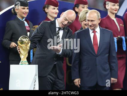 File photo dated 15-07-2018 of FIFA President Gianni Infantino (left) and Russian President Vladimir Putin with the World Cup trophy. As the Russian invasion of Ukraine continues, FIFA said on Sunday that Russia must play international matches in neutral countries without supporters, flags and anthems. With World Cup play-offs on the horizon the decision was met with criticism, with the Polish FA - due to meet Russia on March 24 - saying it will not fulfil the fixture, calling the move “unacceptable” Issue date: Monday February 28, 2022. Stock Photo