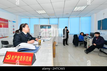 (220228) -- TIANJIN, Feb. 28, 2022 (Xinhua) -- Wang Yan (1st L) talks with colleagues at a bus service office in north China's Tianjin, Feb. 24, 2022. Tianjin bus driver Wang Yan is a National People's Congress (NPC) deputy. Since taking on her duties in 2018, Wang has continued to submit suggestions to the NPC, covering a variety of areas, such as transportation and health care. As a bus driver, she makes the most of her job, listening to her passengers' opinions, while formulating suggestions that can have an influence on government policies. This year is the last year of her term of NP Stock Photo