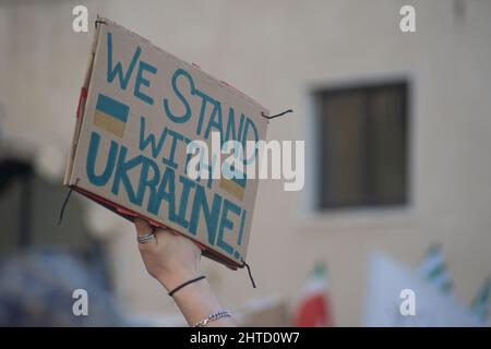 Student holding a sign in support of Ukraine during demonstration against Russian attacks Stock Photo