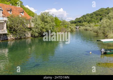 Calm Shkodra Lake and the surronding green hill in Virpazar, Montenegro Stock Photo