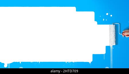 Paint roller painting white paint in a blue wall. Creative copy space for marketing or advertising. Stock Photo