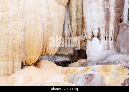 Stalactites formed from calcium carbonate in Bagni San Filippo form bizarre silhouettes. Tuscany, Italy Stock Photo