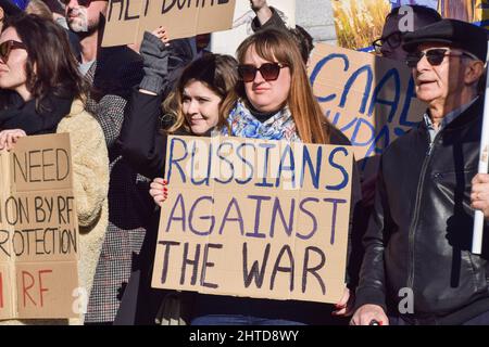 London, UK. 27th February 2022. A protester holds a 'Russians Against The War' placard. Thousands of protesters gathered in Trafalgar Square as the war in Ukraine continues. Stock Photo