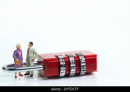 a couple in love is in a shackle of a red combination padlock Stock Photo