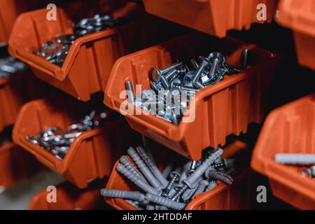 Small boxes with screws and nuts in a workshop Stock Photo