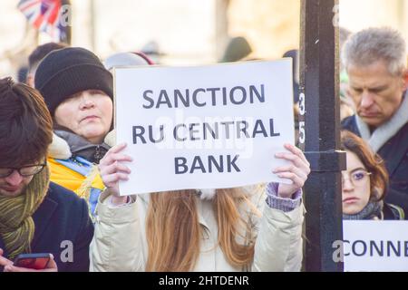 London, UK. 24th February 2022. A protester calls for sanctions on the Russian Central Bank. Demonstrators gathered outside Downing Street in protest against the Russian invasion of Ukraine, and called on the UK Government to help Ukraine and place additional sanctions on Russia. Stock Photo