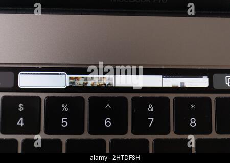 A top view of tabs open in Safari showing on touch bar of MacBook Pro laptop Stock Photo