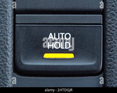 Button of a modern parking brake system in a car Stock Photo