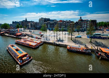 Aerial view of Amsterdam canal with tourist boats near Amsterdam Centraal Stock Photo