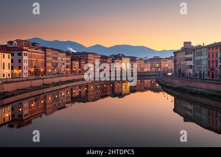 Pisa, Italy skyline on the Arno River at dusk. Stock Photo