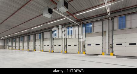Interior of a new empty warehouse with loading docks ready to be used Stock Photo
