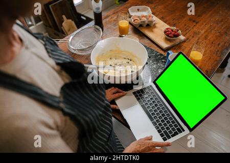 baking in the kitchen with top view of laptop screen for recipes  Stock Photo