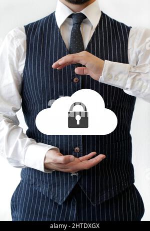 Businessman holding a cloud with a padlock Stock Photo