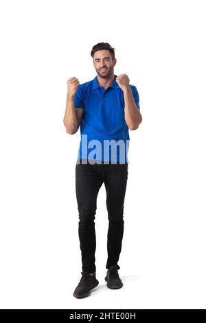Full length casual portrait of handsome tall successful young man holding fists isolated on white background Stock Photo