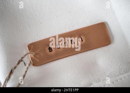 First name Susan identity engraved name dog tag copper metal name plate badge. Shiny and clean stamped letters on retro trinket pendent. Stock Photo