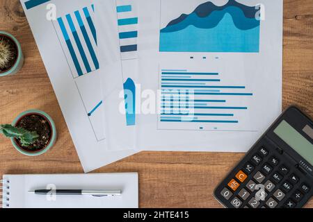 Top view photo of business workers desktop with graphics and statistics. Finance and business accounting concept. Stock Photo