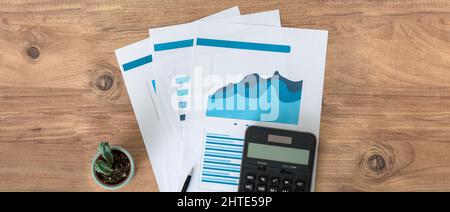 Top view photo of business workers desktop with graphics and statistics. Finance and business accounting concept. Stock Photo