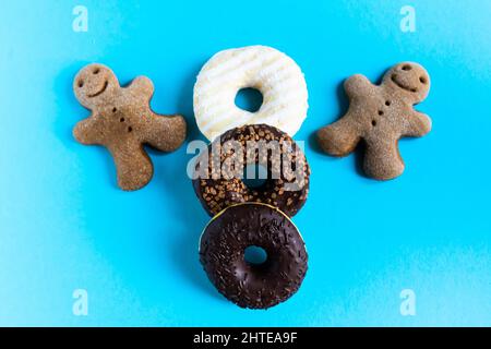 Donut with hazelnuts on a blue background, close up Stock Photo