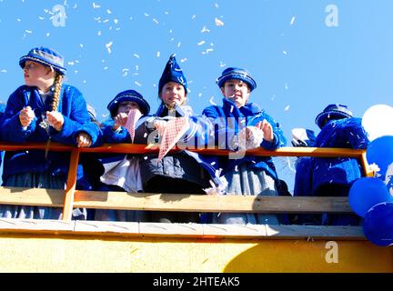 Maastricht, The Netherlands. 28th Feb 2022. Young members of the local carnival association 'CV de Sjlaaibök' of Amby (Maastricht) enjoying the open-top bus ride during the parade on Carnival Monday. Anna Carpendale/Alamy Live News Stock Photo