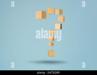 Floating question sign made of wooden blocks. Concept of FAQ and solving problem by providing information and answer. Stock Photo