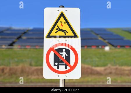 High voltage in overhead electric power lines and climbing on train forbidden warning signs Stock Photo