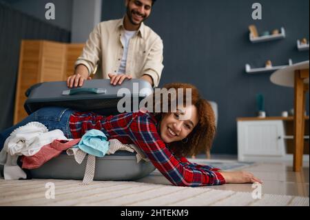 Funny loving couple preparing for vacation trip Stock Photo