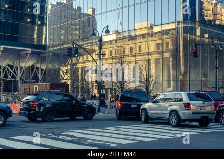 The Daniel Patrick Moynihan Train Hall at Pennsylvania Station in New York is reflected in the glass facade of One Manhattan West, a Brookfield property, on Friday, February 18, 2022. Traffic on Ninth Avenue is backed up as drivers attempt to enter the Lincoln Tunnel. (© Richard B. Levine) Stock Photo