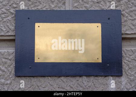 Memorial Gold Plaque Sign at Building Wall Copy Space Stock Photo