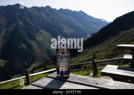 OBERSULZBACH , AUSTRIA 19 September , 2020 A can of Zipfer beer on a table with a mountain panorama Stock Photo