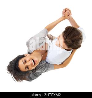 He know how to blow her away. A multi-ethnic couple dancing isolated on a white background - high angle view. Stock Photo