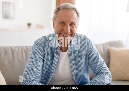 Mature man having rest at home on the couch Stock Photo