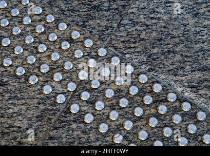 Warning bumps for blind people on granite floor Stock Photo