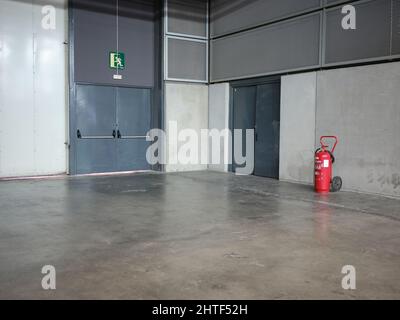 Emergency exit doors of an industrial area with a fire extinguisher Stock Photo