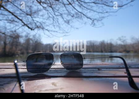 classical sunglass standing at wooden table and lake background in Bursa, floodplain in Karacabey Stock Photo