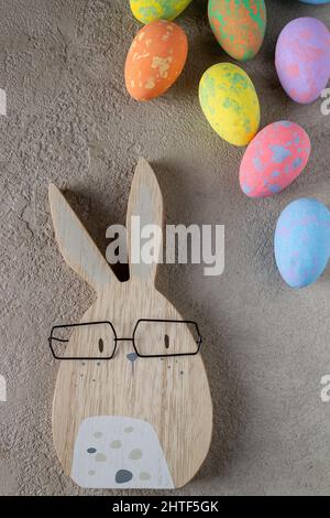 rabbit and colored easter eggs on a gray background Stock Photo