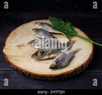 Sun dried fish over wooden background. Snack for beer Stock Photo