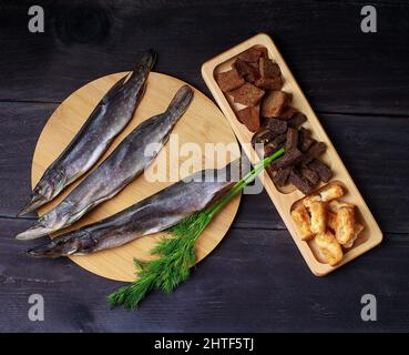 dried fish wooden background, top view, copy space. Snack for beer Stock Photo