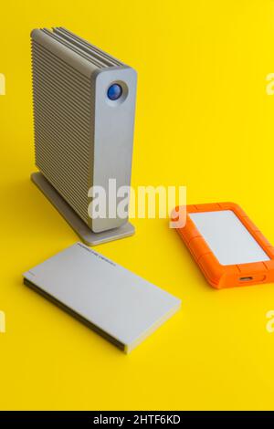 selection of external hard drives on a yellow background Stock Photo